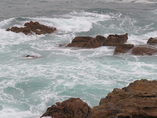 watching the waves playing with the rocks