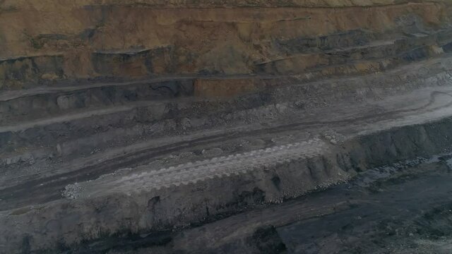 Aerial view panorama of coal quarry. In the center of the shot is a site with Openings for explosives. There are explosives next to the wells. Preparation of an explosion at the quarry site.

