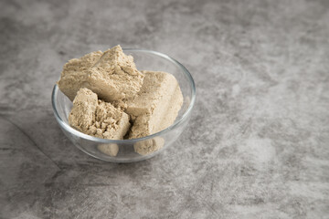 Transparent plate with halva made from sunflower seeds . Vegan product