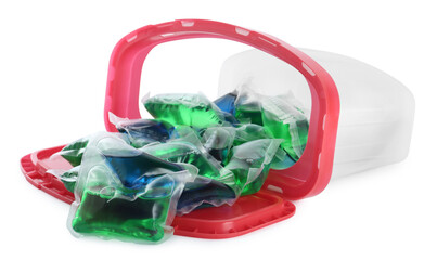 Overturned box with laundry capsules on white background