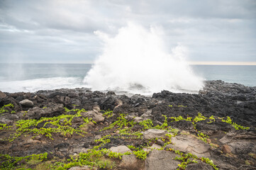 big wave crashing on rocky coast