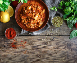 Traditional curry and ingredients. Tikka Masala chicken and rice. Indian food. Top view. Copy space. Wooden background.