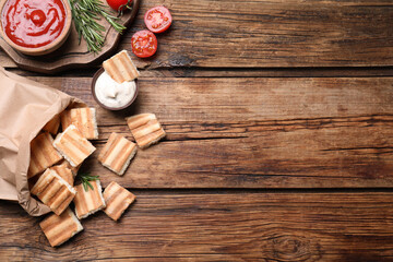 Delicious pita chips on wooden table, flat lay. Space for text