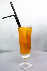 orange cocktail with a slice of orange in a glass glass