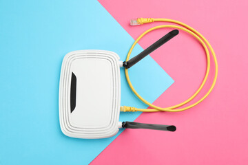 Modern Wi-Fi router on color background, top view