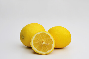 Ripe full yellow lemon. Lemon isolated on white background. Lemon, Citrus limon. Fresh organic yellow lemon lime fruit with slices and green leaves isolated on white background . 