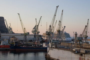 Fototapeta na wymiar Palermo shipyard in Italy, ships in storage and cranes in the shipyard 