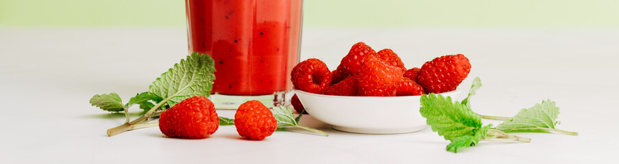 glass with red smoothie. Healthy eating and sustainability. Smoothie made from raspberries and other red fruits. Zero waste. Banner