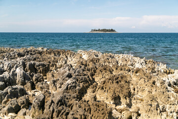 Beautiful shot of calm sea with an Istria peninsula in a distance in Vrsar, Croatia