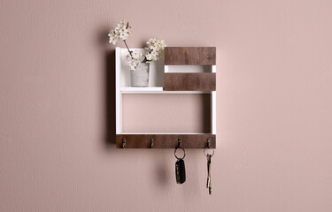 Wooden hanger for keys on color wall