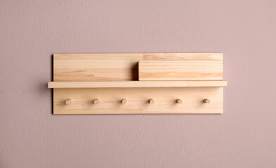 Wooden hanger for keys on color wall