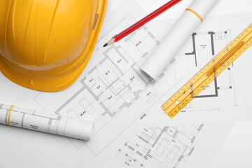 Flat lay composition with blueprints and hardhat on white background