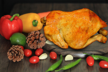 Roasted chicken with spices on wooden cutting board