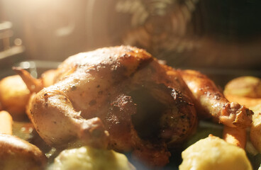 Oven baked chicken with potatoes and carrots.