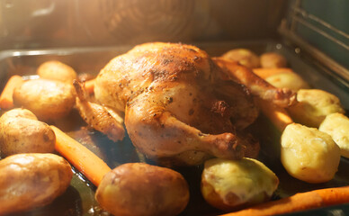 Oven baked chicken with potatoes and carrots.