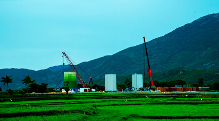 Fototapeta premium Wind Turbine Tower Construction On Sunny Day - Sustainable Investment
