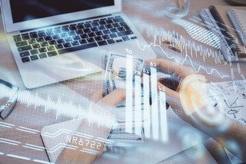 Multi exposure of Tech drawing hologram and USA dollars bills and man hands. Technology concept.