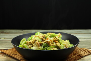 Traditional fried and stirred cutting zucchini mixed with egg and dried shrimp serving on the plate. Famous side dish menu in Asian restaurant. 