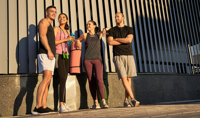 Smiling athletes are posing together before training