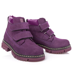 Close up of a pair of dark purple shoes for women and girls on a white background.