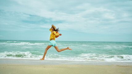 Running happy woman on sandy sea beach, enjoying seascape, feeling freedom.