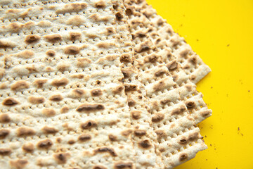 Traditional Jewish kosher matzo for Passover. Set with Passover matzos on yellow background. Pesach celebration