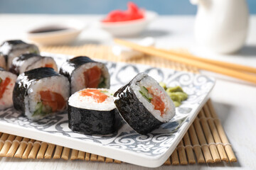 Tasty sushi rolls with wasabi served on table, closeup