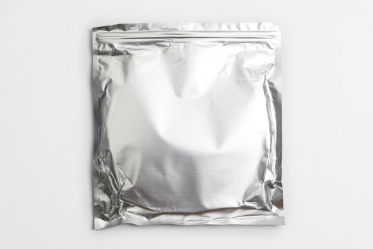 Foil bag package isolated on white background. Silver aluminium metallic foil doypack, packaging pouch with zipper