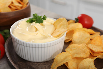 Potato chips with mayonnaise on table, closeup