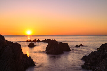 Beautiful calm sea and sunset scenery on the ocean as light reflects on the water