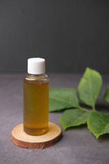  eucalyptus essential oils in a glass bottle with green leaf on black background