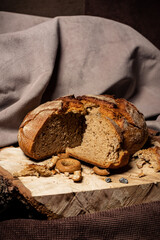 Bread and drying lie on a wooden board on a dark background