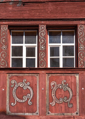 Close up of decorated windows of a wooden medieval house in Werdenberg, Switzerland