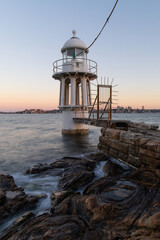 Fototapeta na wymiar Sunset view of Robertson Point lighthouse in Sydney Harbour.