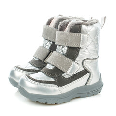 Side view of children's shiny winter boots for a girl of silver color. Isolated.