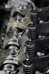 Obraz na płótnie Canvas Detail of modern diesel engine repair, closeup of injectors in cylinder head with camshaft, selective focus
