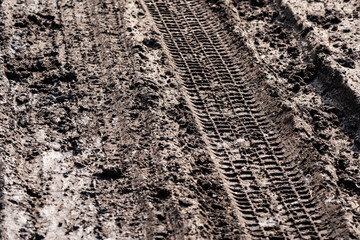 the muddy road is dry in the sun and plays an interesting pattern and imprints