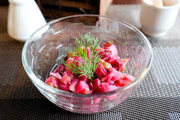 Vinaigrette in a transparent salad bowl. Portion lunch
