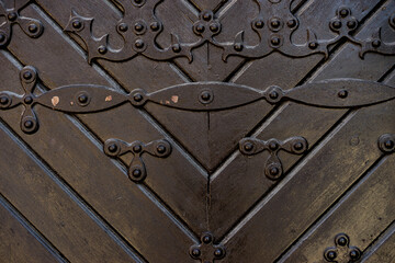 old dark wooden door with iron handles