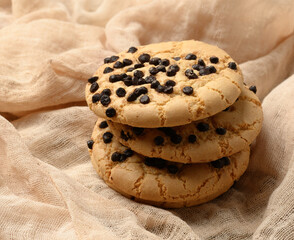round cookies with pieces of chocolate on a textile towel