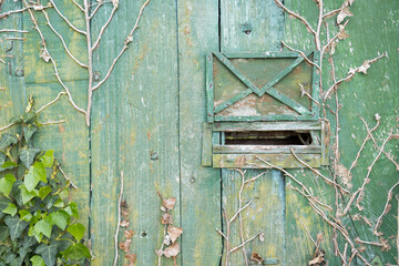 Old mailbox on wooden door. vintage background