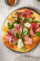 Pizza with asparagus, ham and mozzarella. Delicious lunch or dinner.