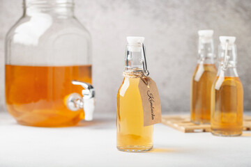 Refreshing filtered kombucha tea in a glass bottle and a jar. Healthy drink