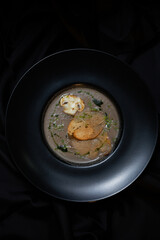 porcini mushroom soup in a black dish