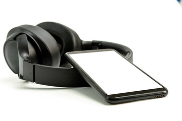 headphones with Bluetooth technology on white background, with black phone paired for music lovers