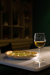 glass of white wine and pizza cheese