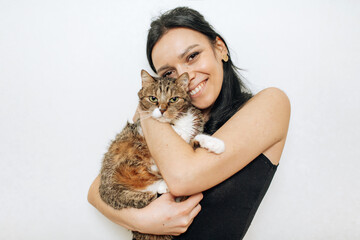 beautiful smiling brunette girl and her cat over white background