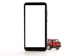 red toy car and smartphone isolated on white, concept of online carsharing, rent, buy, navigatin