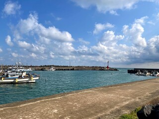 sunset over the ocean, breakwater and wharf in the background