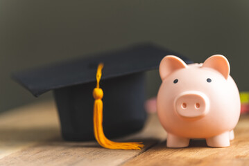 piggy bank With Graduation Cap on old wood,Money saving concept..